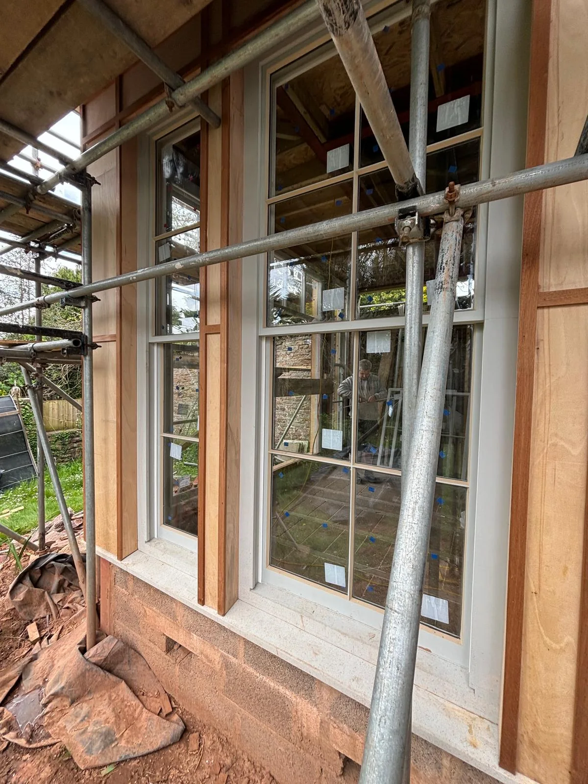 New Accoya sash windows being fitted in a renovated room.