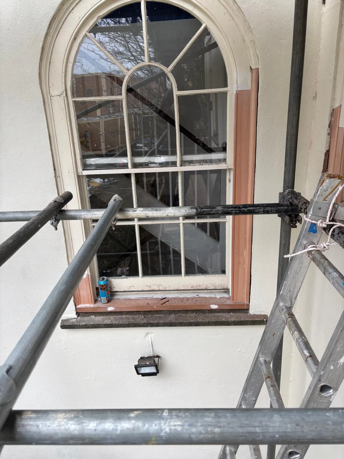 Arched sash window during timber repairs from scaffold.