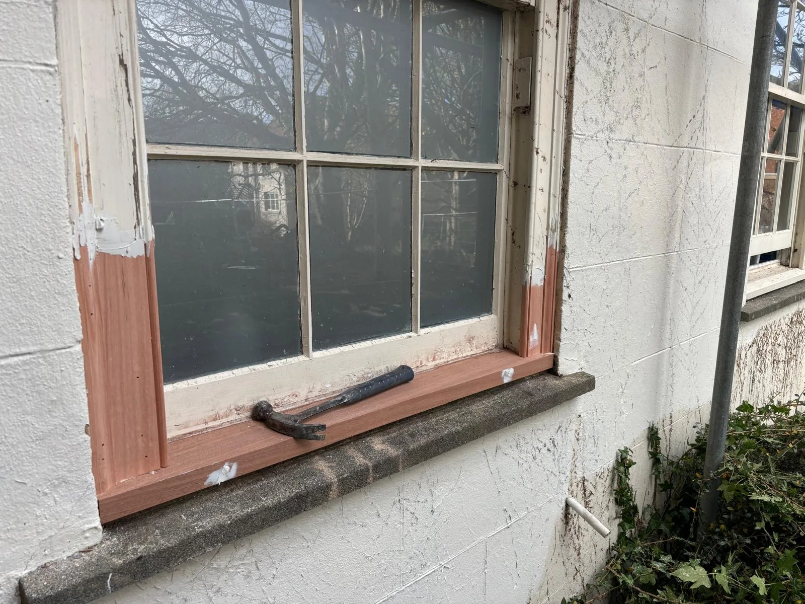 Repaired sash window sill and timber jambs.