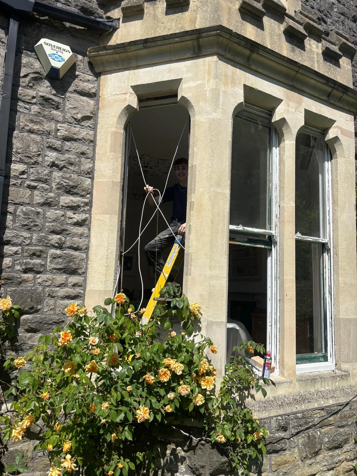 Close view of repairing sash windows in a stone facade.