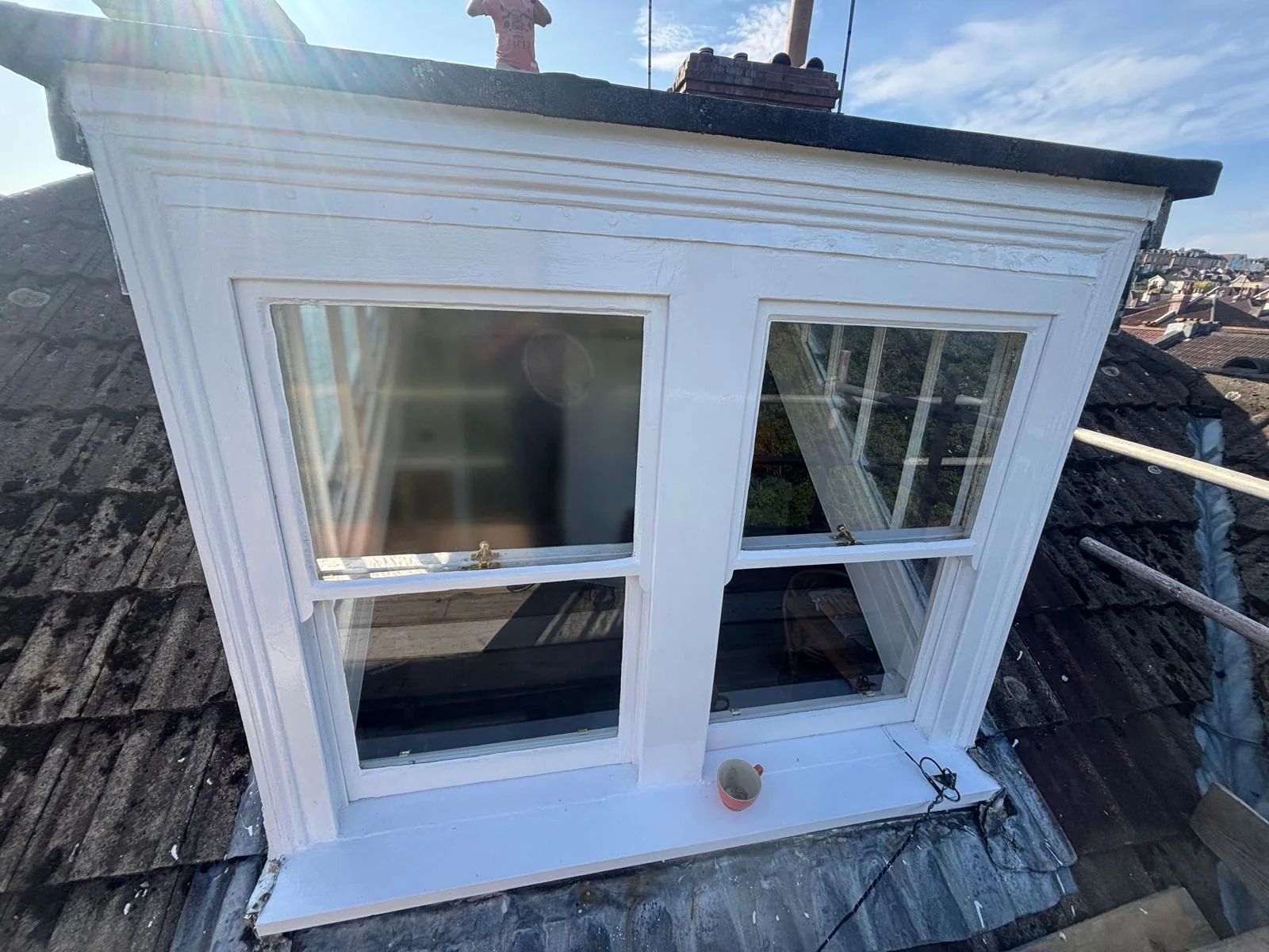 Refurbished white sash windows and roof detail on a Clifton dormer.