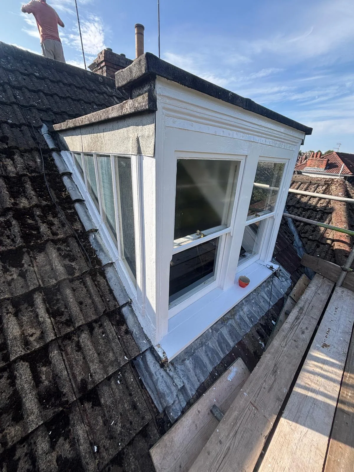 Refurbished white sash windows in a Clifton roof dormer, viewed from the side.
