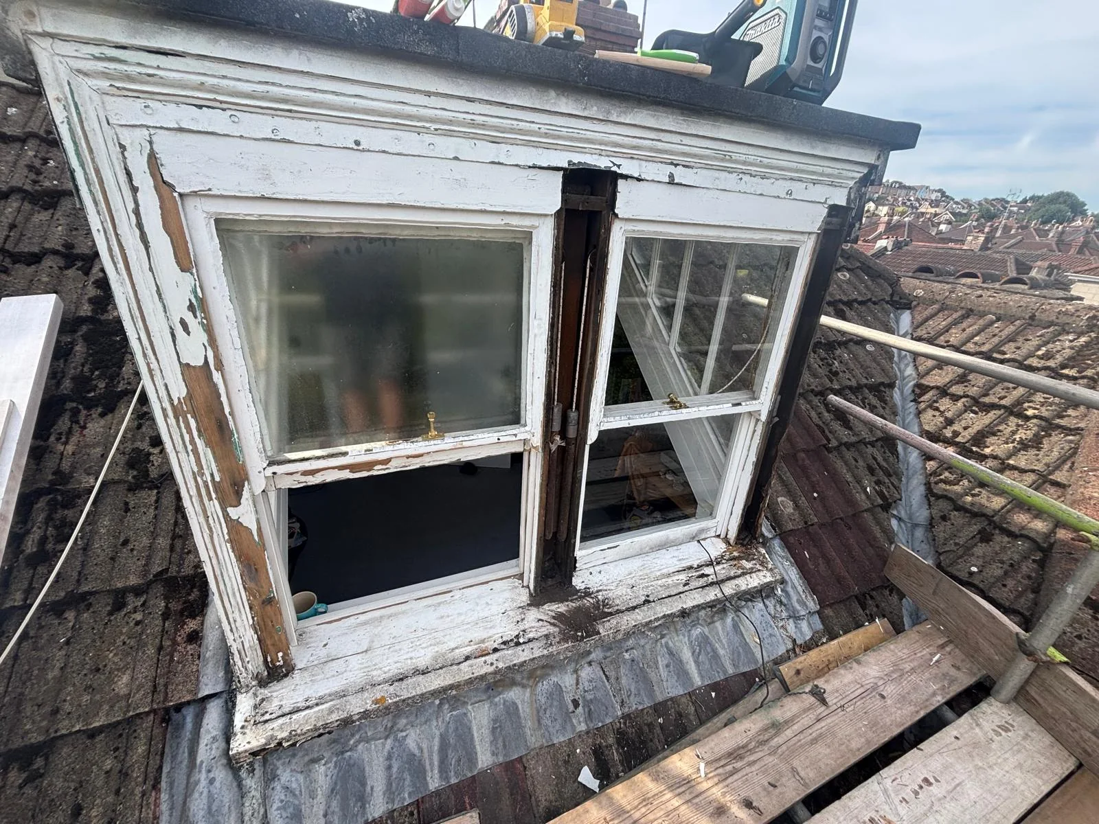 Weathered sash windows in a Clifton dormer before refurbishment.