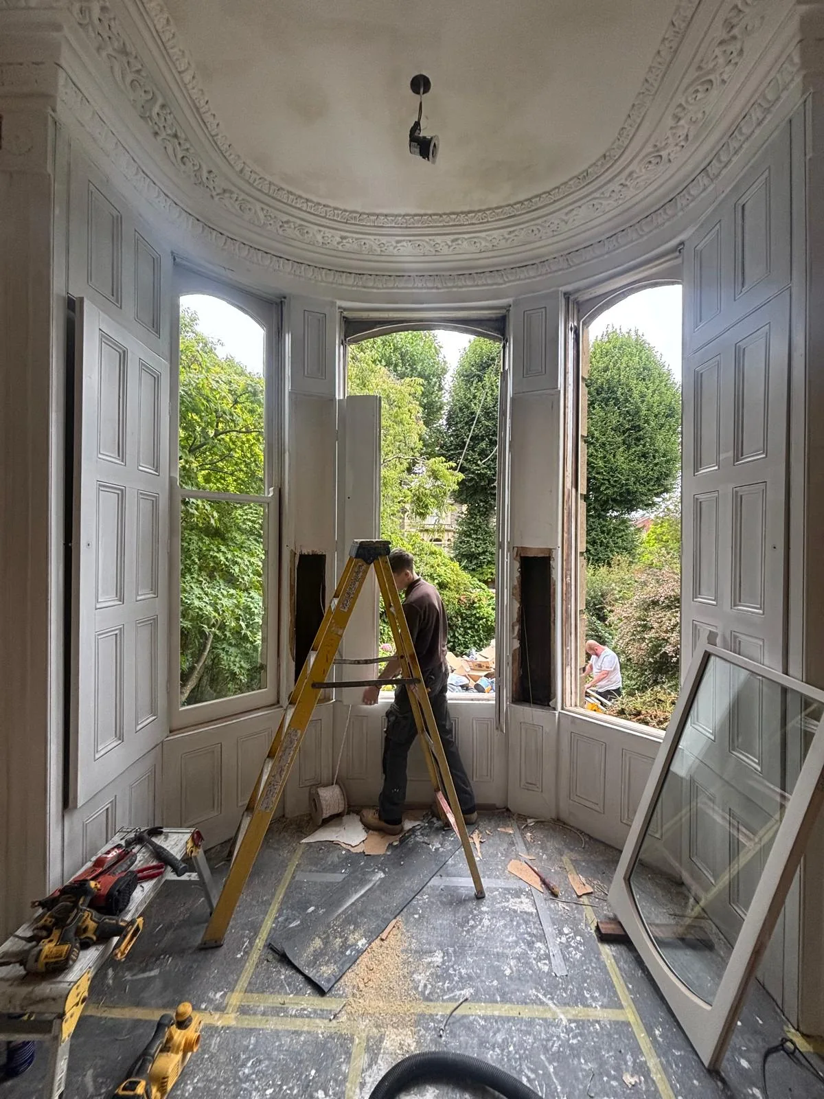 Wide interior view of curved bay window refurbishment.
