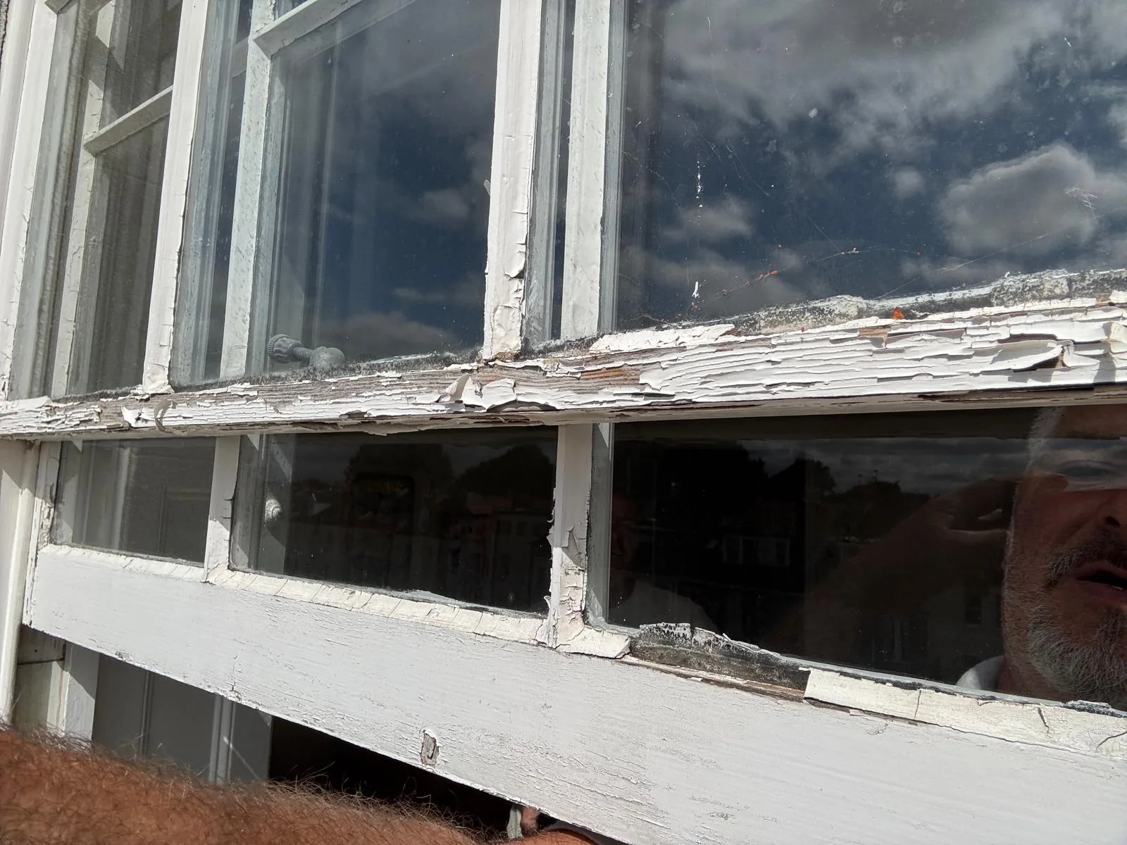 Close-up of decayed timber rail on a sash window.