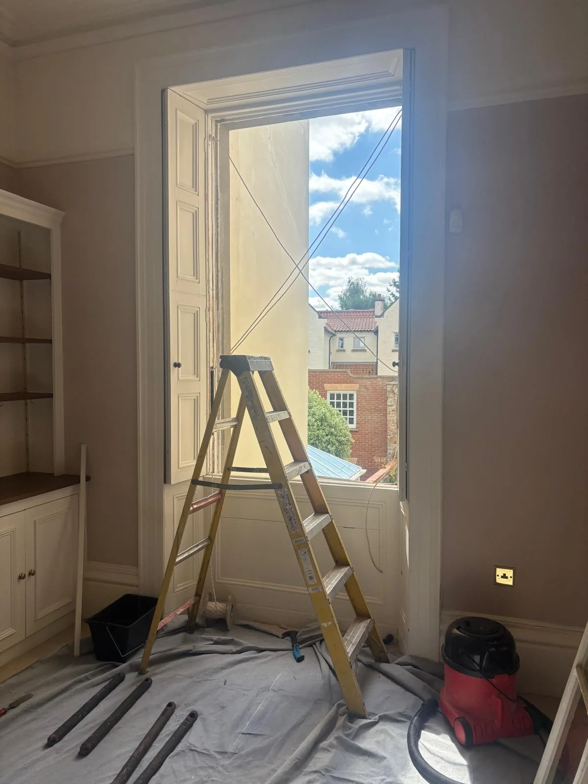 Interior view of a sash window project with installer at work.
